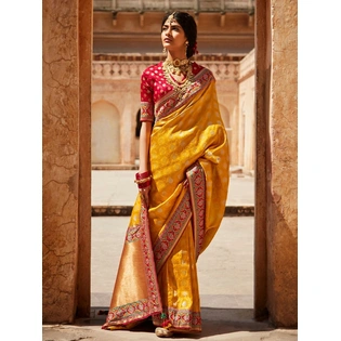 Sabyasachi-Inspired Tangerine Orange Silk Blend Saree & Red Designer Blouse Featuring Gold Zari Accents, Elegant Indian Wedding And Festive Sari In The India